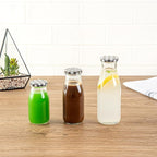 Restaurantware French Countryside 15 Ounce Glass Bottles 10 Durable Juice Bottles - With Black Plaid Lid Dishwashable Clear Glass Countryside Bottles For Hot And Cold Beverages